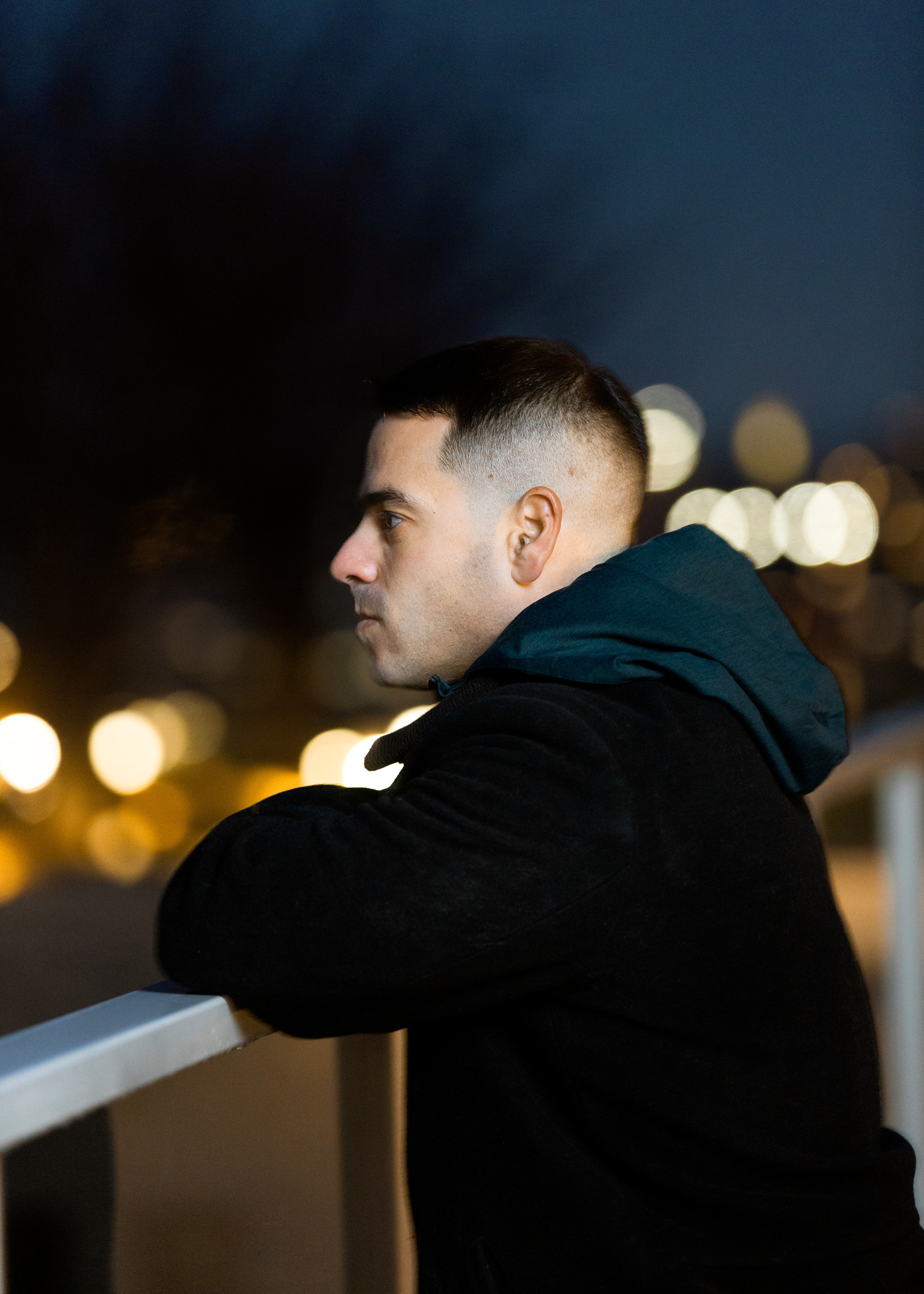 Andrew Weiss night profile on railing